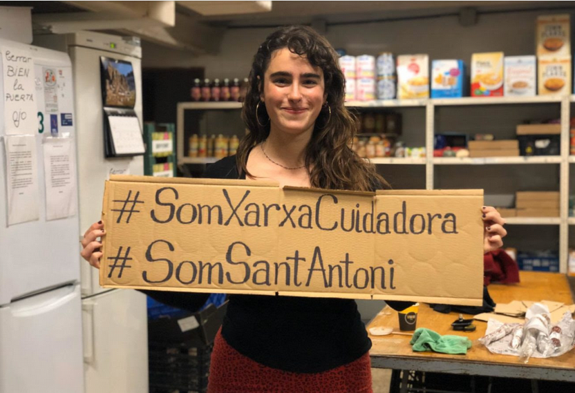 Una dona amb un cartell que diu #SomXarxaCuidadora #SomSantAntoni